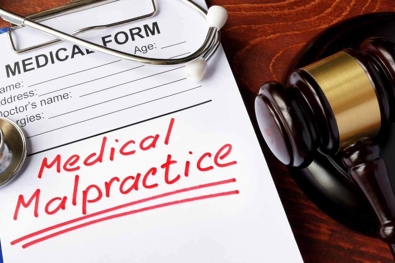 Medical form with words Medical Malpractice and gavel. Yes, It Is Possible To Recover Damages From Uninsured Doctors In Florida