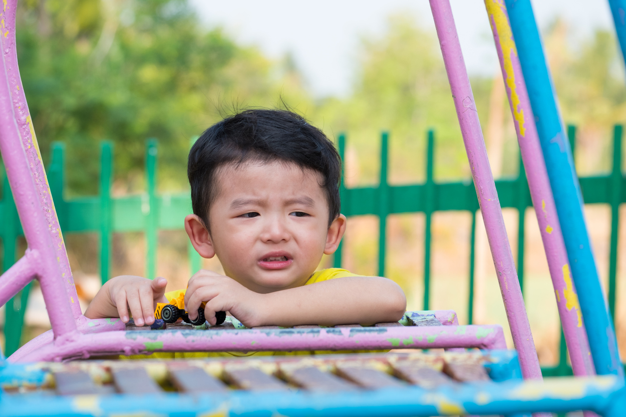 Sad little Asian kid at the playground under the sunlight. Daycare Negligence | Documentation In Daycare Negligence